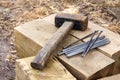 Vintage old rusty hammer and nails lying on wooden bars Royalty Free Stock Photo