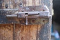 Vintage old rusty latch on old wooden door Royalty Free Stock Photo