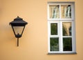 Vintage street lamp hanging on the wall of a house with a window in St. Petersburg Royalty Free Stock Photo