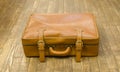 Vintage old suitcase on a wooden floor Royalty Free Stock Photo