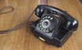 Vintage old telephone on wooden desk. technology of yesteryear Royalty Free Stock Photo