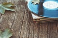 Vintage old vinyl records on wooden autumn background, selective focus decorated with few leaves. Music, fashion, texture, Royalty Free Stock Photo