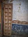 Vintage old warehouse wooden brown painted door with ancient brick wall of limestone. Front view of gates to abandoned warehouse Royalty Free Stock Photo