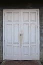 The vintage old white doors is close in vintage wall Royalty Free Stock Photo