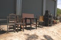 Vintage Old Wooden Chairs/Stools and Table with Roller Shutter Background - Outside Studio Garage/ Backyard/ Junkyard Royalty Free Stock Photo