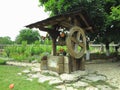 Vintage old wooden water well with huge wheel Royalty Free Stock Photo