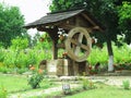 Vintage old wooden water well with huge wheel Royalty Free Stock Photo