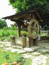 Vintage old wooden water well with huge wheel Royalty Free Stock Photo