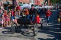 Vintage 1901 Olds replica carriage in small town Applefest parade