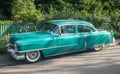 Old green Cadillac on a sandy road Royalty Free Stock Photo