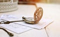 Vintage open pocket watch and antique letter. Retro still life