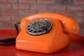 Vintage orange telephone on red background Royalty Free Stock Photo