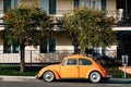 Vintage orange Volkswagen Beetle, on Pacific Coast Highway in Laguna Beach, California