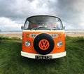 A vintage orange VW campervan transport