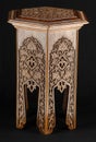 Vintage oriental wooden table with artistic carving isolated on a black background