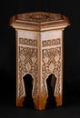 Vintage oriental wooden table with artistic carving isolated on a black background