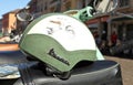 Vintage original leather covered helmet with the brand Vespa, on the seat of the famous italian scooter of the Sixties