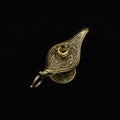 Vintage Ornate Ancient Aladdin Lamp on black background. Magical Mysterious Genie Lamp of Desire. Abracadabra spell.