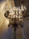 A vintage ornate lamp illuminating a dark room