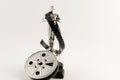 Vintage Oscar statue with movie reel desaturated