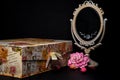 Vintage Oval Desk Mirror with white frame, Potpourri pieces and a keepsake box on black background Royalty Free Stock Photo