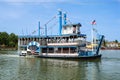 Vintage paddlwheel steamboat painted in old-fashioned American in the river Royalty Free Stock Photo