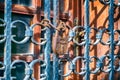 Vintage padlock locking an iron gate