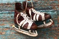 Vintage pair of mens ice skates on a wooden wall Royalty Free Stock Photo