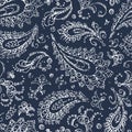 Vintage paisley ornament - seamless pattern. Grunge texture. White flowers, leaves and curls on a blue background. Handmade.