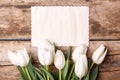 Vintage paper card with tulips on wood background Royalty Free Stock Photo