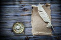 Vintage paper scroll quill candlestick on blue wooden background