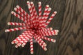 Vintage paper straws in glass on wood table