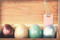 Vintage paper textures, Colorful easter egg in wood box with paper tag Royalty Free Stock Photo