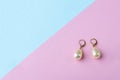 Vintage pearl jewelry earrings on pink blue background. Elegant gift for woman