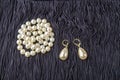 Vintage pearl jewelry on little black dress. Gatsby or Chicago fashion look. Luxury white necklace and earrings. Getting ready for