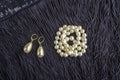 Vintage pearl jewelry on little black dress. Gatsby or Chicago fashion look. Luxury white necklace and earrings. Getting ready for