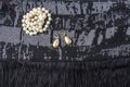 Vintage pearl jewelry on little black dress. Gatsby or Chicago fashion look. Luxury white necklace and earrings. Getting ready for