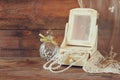 Vintage pearls , antique wooden jewelry box with mirror and perfume bottle on wooden table. filtered image Royalty Free Stock Photo