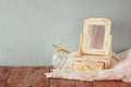 Vintage pearls , antique wooden jewelry box with mirror and perfume bottle on wooden table. filtered image Royalty Free Stock Photo