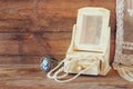 Vintage pearls , antique wooden jewelry box with mirror and perfume bottle on wooden table. filtered image Royalty Free Stock Photo