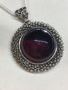 Vintage pendant with a large round red Mexican amber in a silver frame.