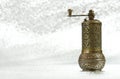 Vintage pepper mill on silver background. Spice grinder. Sample for traditional packing of pepper seed. Close-up Royalty Free Stock Photo