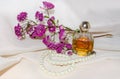 Vintage Perfume Bottle with dry roses and pearls Royalty Free Stock Photo