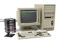 Vintage personal computer setup with beige tower monitor keyboard and floppy disk stack Royalty Free Stock Photo