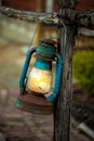 Vintage petrol lantern hanged by fence