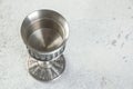 Vintage pewter goblet on concrete background