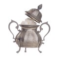 Vintage pewter sugar bowl with lid off to show white sugar cubes, isolated on white background. Highly decorated, ornate