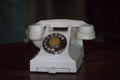 Vintage phone light beige with dialer on dark background.