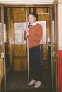 vintage photo of agitated and sad man in wagon train or tram holds rod