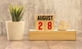 Vintage photo, August 28th. Date of 28 August on wooden cube calendar, copy space for text on board